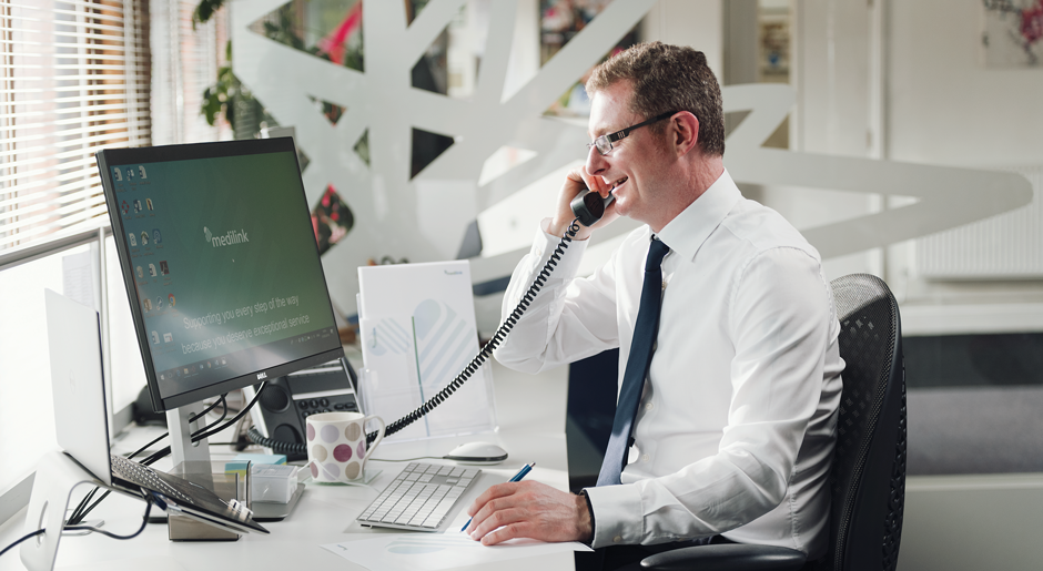 Man on the phone to Medilink Customer Services